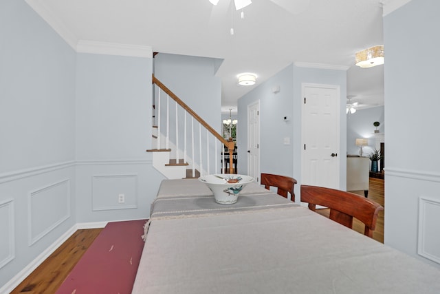 1394 Center Lake Dr, Mount Pleasant, SC 29464 - dining area with ceiling fan, wood finished floors, stairs, a chandelier, and wainscoting