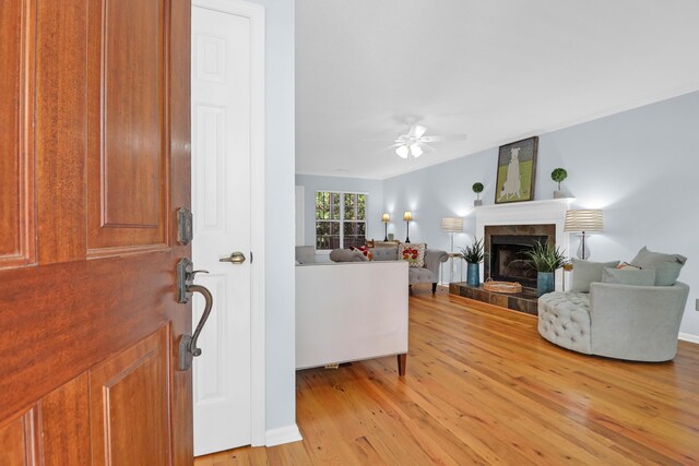 1394 Center Lake Dr, Mount Pleasant, SC 29464 - entryway featuring light wood-type flooring, ceiling fan, a tile fireplace, and baseboards