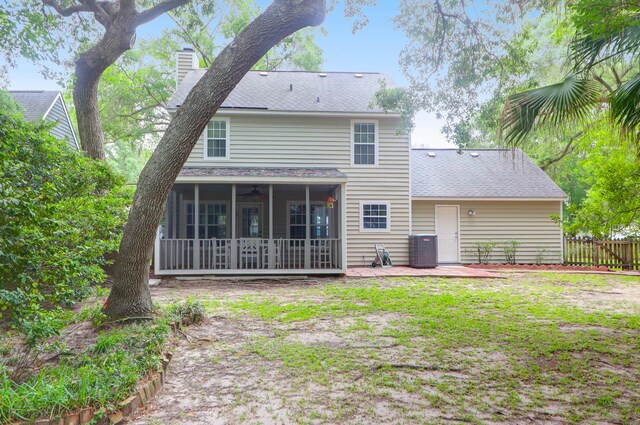 1394 Center Lake Dr, Mount Pleasant, SC 29464 - rear view of property with a sunroom, a chimney, a shingled roof, ceiling fan, and a patio