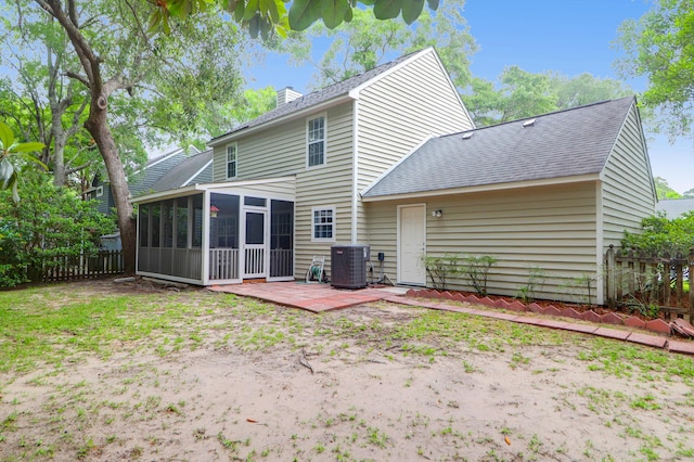 1394 Center Lake Dr, Mount Pleasant, SC 29464 - back of property with a sunroom, a chimney, central AC unit, roof with shingles, and a patio area