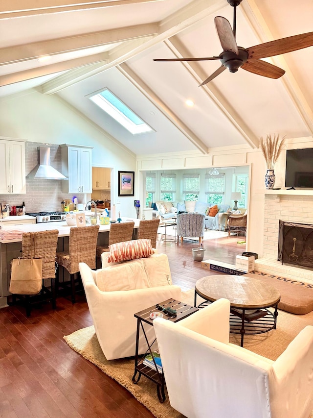 1015 Jacksnipe Ln, Mount Pleasant, SC 29464 - living room with a skylight, dark wood-style floors, a brick fireplace, and ceiling fan