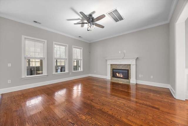 unfurnished living room with baseboards, a fireplace with flush hearth, visible vents, and wood finished floors