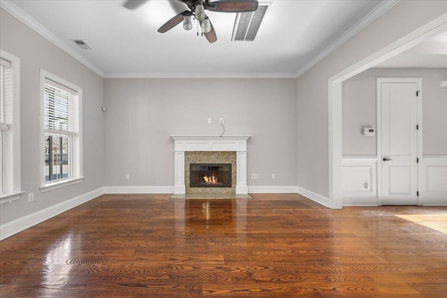 unfurnished living room featuring a fireplace, visible vents, dark wood finished floors, and crown molding