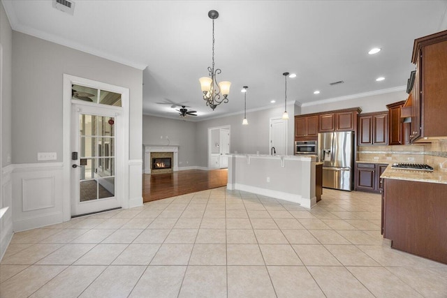 kitchen featuring light tile patterned flooring, visible vents, open floor plan, appliances with stainless steel finishes, and pendant lighting