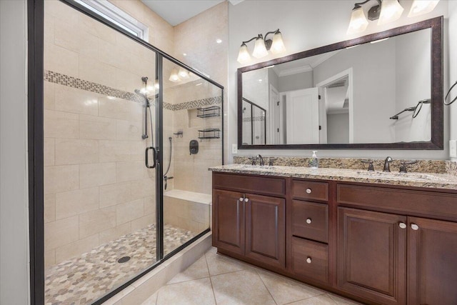 bathroom with double vanity, a stall shower, a sink, and tile patterned floors