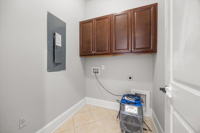 clothes washing area with light tile patterned floors, hookup for a washing machine, cabinet space, electric dryer hookup, and electric panel