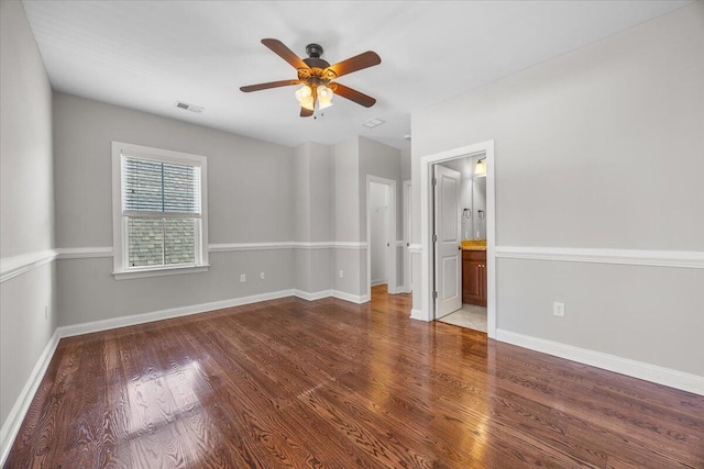 unfurnished bedroom featuring a ceiling fan, baseboards, visible vents, and wood finished floors