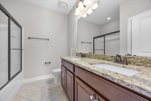 bathroom with combined bath / shower with glass door, a sink, toilet, and tile patterned floors