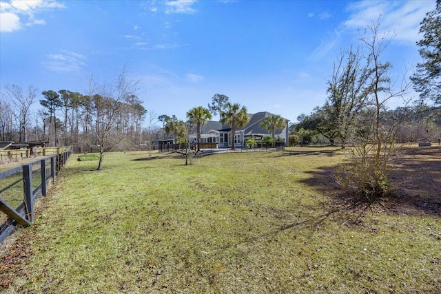 view of yard featuring a rural view and fence