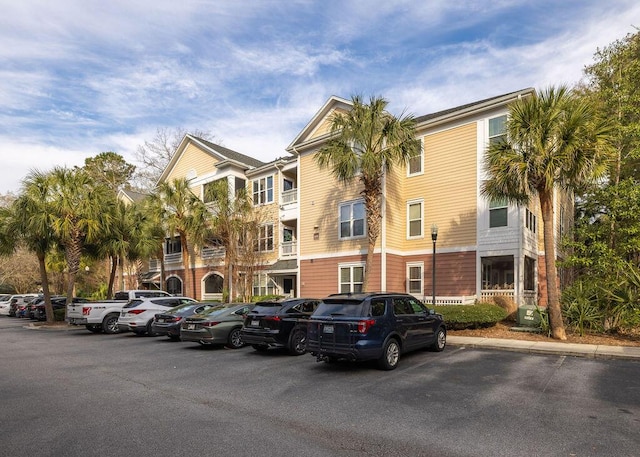 view of building exterior featuring uncovered parking