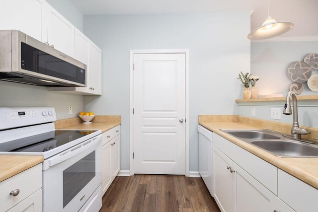 kitchen with dark wood-style flooring, a sink, white appliances, light countertops, and white cabinetry