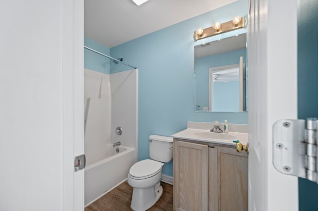 full bathroom featuring toilet, hardwood / wood-style floors, vanity, and shower / bathing tub combination