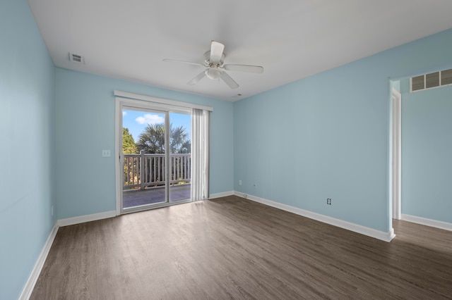 empty room with dark wood-type flooring and ceiling fan