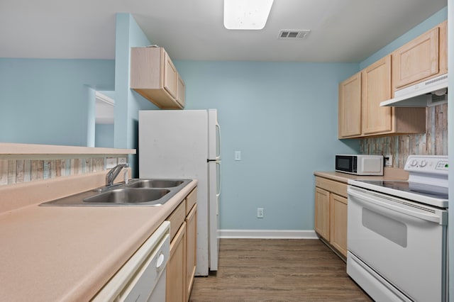 kitchen featuring light brown cabinets, dark hardwood / wood-style flooring, sink, and white appliances