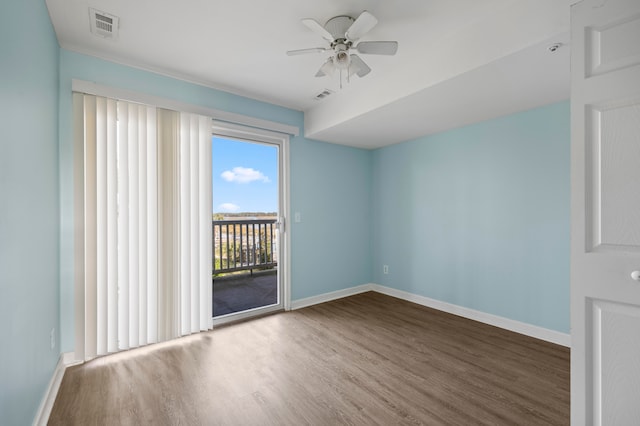 spare room with hardwood / wood-style floors and ceiling fan