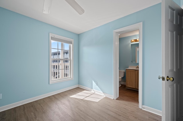 spare room featuring ceiling fan and light hardwood / wood-style flooring