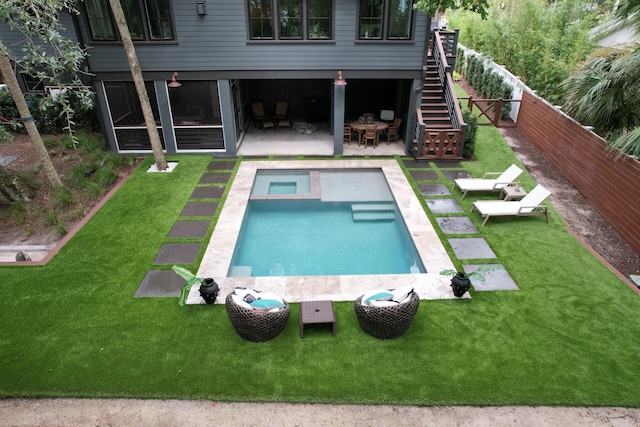 outdoor pool featuring a lawn, a patio, stairs, and a fenced backyard