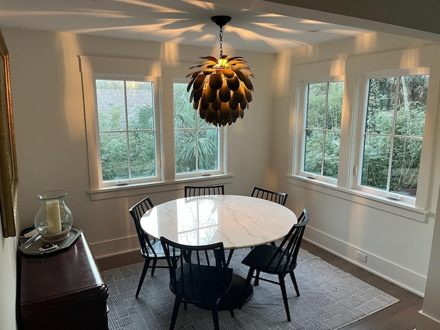 dining area featuring dark wood-style floors and baseboards