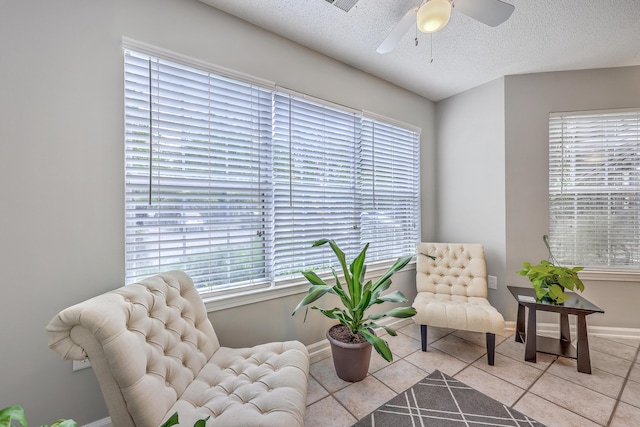 188 Midland Pkwy Unit 516, Summerville, SC 29485 - sitting room featuring tile patterned flooring, a ceiling fan, a textured ceiling, healthy amount of natural light, and baseboards