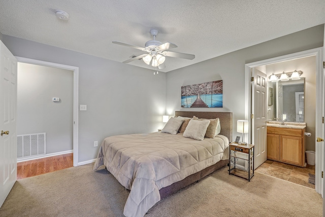 188 Midland Pkwy Unit 516, Summerville, SC 29485 - bedroom with light colored carpet, a sink, a textured ceiling, ensuite bathroom, and ceiling fan