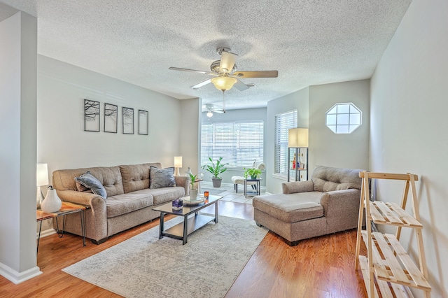 188 Midland Pkwy Unit 516, Summerville, SC 29485 - living area featuring a ceiling fan, a textured ceiling, baseboards, and light wood finished floors