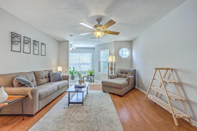 188 Midland Pkwy Unit 516, Summerville, SC 29485 - living room with a ceiling fan, light wood-style flooring, a textured ceiling, and baseboards
