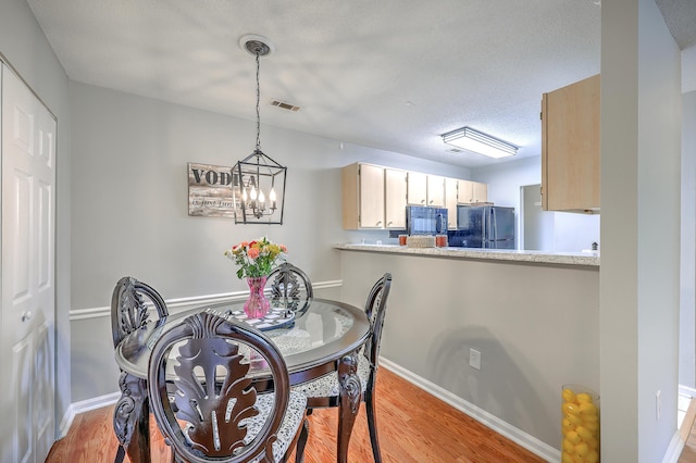 188 Midland Pkwy Unit 516, Summerville, SC 29485 - dining area with light wood-style floors, a chandelier, and baseboards