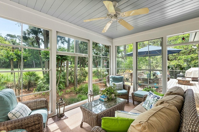 sunroom with outdoor lounge area, a wealth of natural light, and ceiling fan