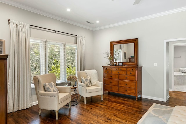 living area featuring wood finished floors, visible vents, crown molding, and baseboards