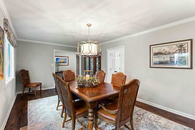 dining space featuring baseboards, a chandelier, and crown molding