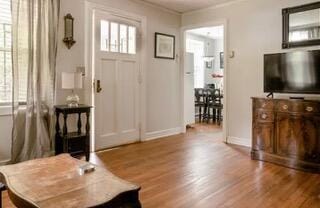 entrance foyer featuring hardwood / wood-style flooring and crown molding