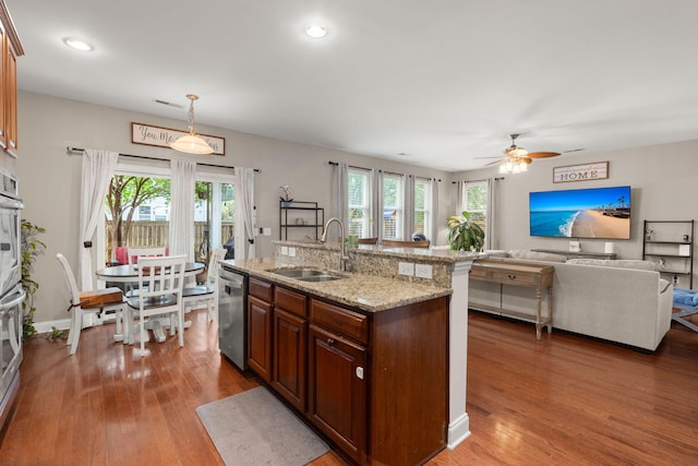 7030 Billberry St, Hanahan, SC 29410 - kitchen with stainless steel dishwasher, wood finished floors, ceiling fan, pendant lighting, and light stone counters