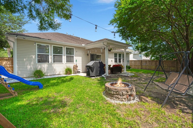 7030 Billberry St, Hanahan, SC 29410 - rear view of property with a playground, a fire pit, a fenced backyard, and a patio area