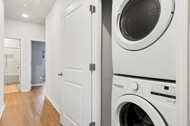 557 Blueway Ave, Summerville, SC 29486 - laundry room featuring stacked washer / dryer, light wood-style floors, baseboards, and recessed lighting