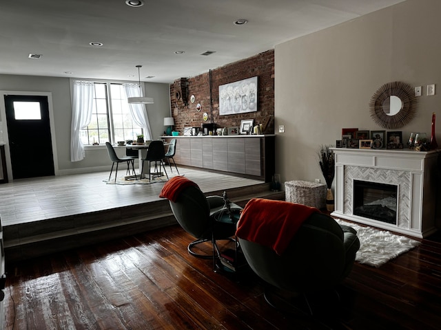 living room with wood-type flooring and a fireplace