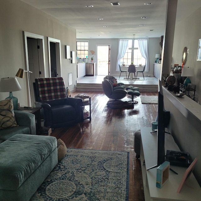 living area featuring hardwood / wood-style floors, visible vents, and recessed lighting