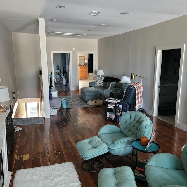 living room with hardwood / wood-style flooring, baseboards, and recessed lighting