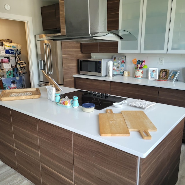 kitchen with light countertops, modern cabinets, glass insert cabinets, stainless steel appliances, and decorative backsplash