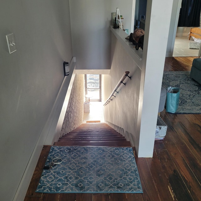 stairs featuring hardwood / wood-style floors