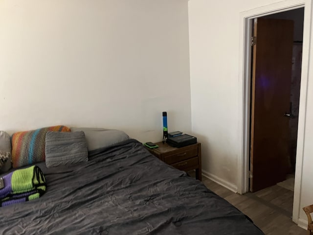 bedroom with hardwood / wood-style floors