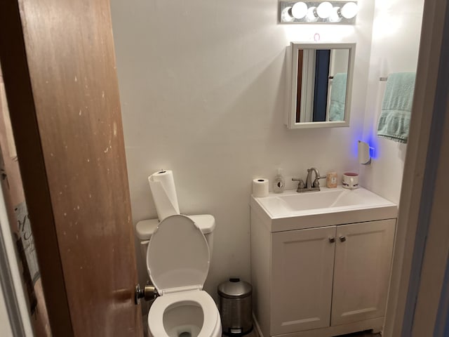 bathroom featuring vanity and toilet