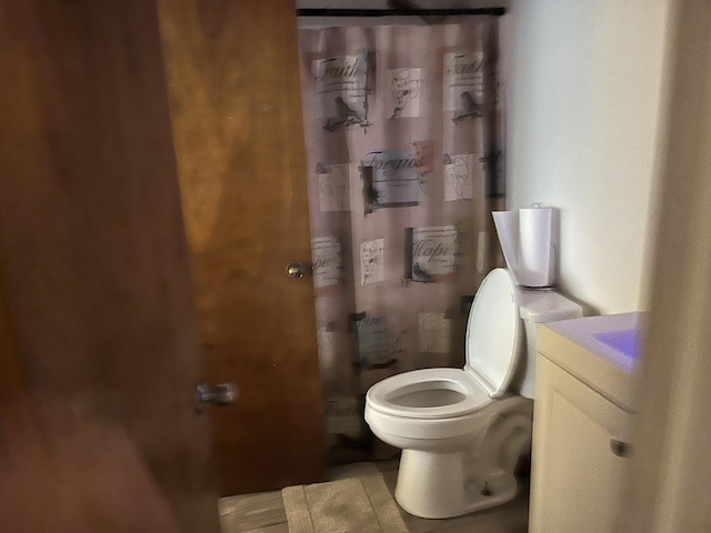 bathroom with vanity, a shower with curtain, and toilet