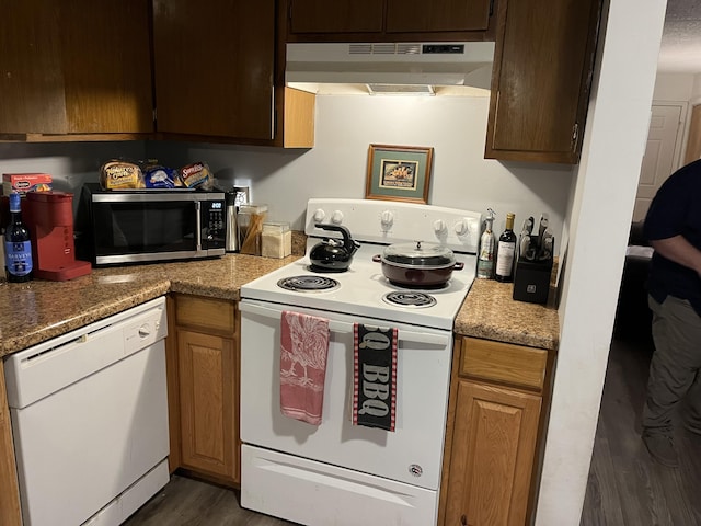 kitchen featuring dark hardwood / wood-style flooring and white appliances