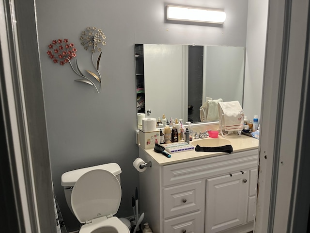 bathroom featuring vanity and toilet