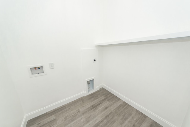 laundry area with hookup for an electric dryer, hookup for a washing machine, and light hardwood / wood-style flooring