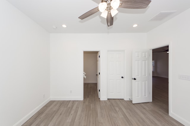 unfurnished bedroom with ceiling fan and light hardwood / wood-style flooring