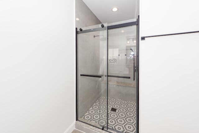 bathroom featuring a shower with shower door