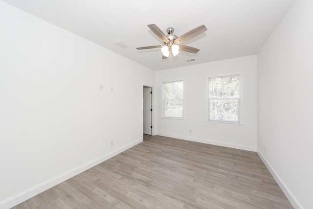 empty room featuring ceiling fan and light hardwood / wood-style floors