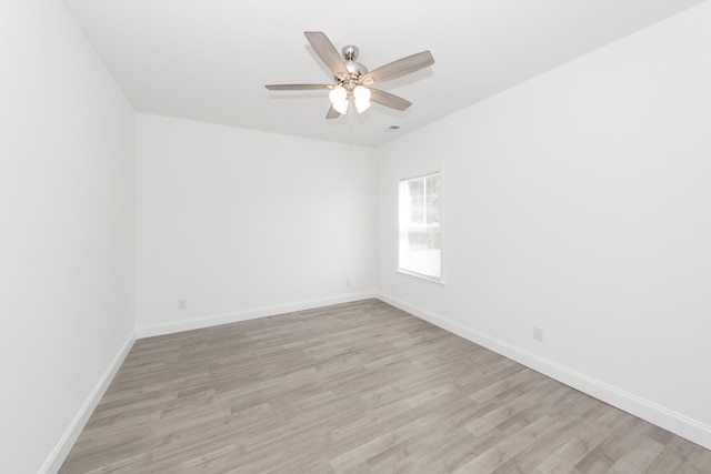 unfurnished room with ceiling fan and light wood-type flooring