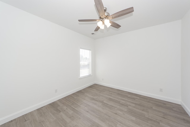 spare room with hardwood / wood-style flooring and ceiling fan